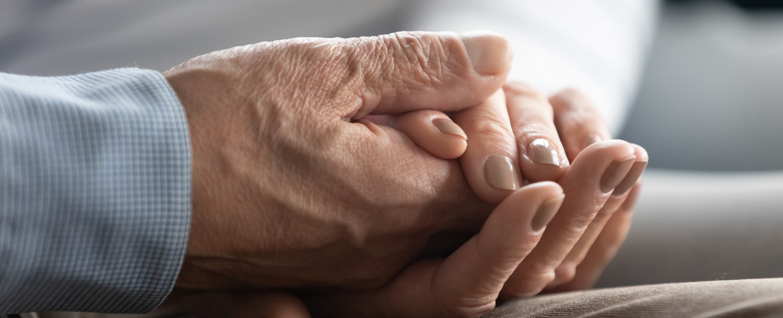 close up of senior couple holding hands