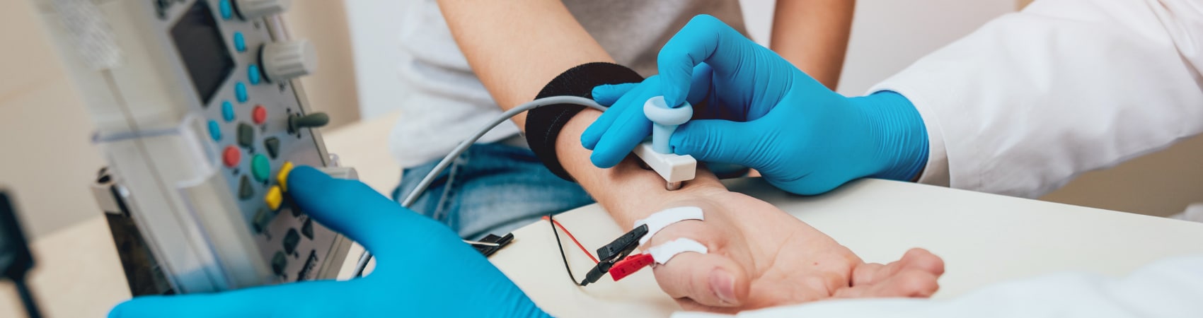 Patient on table getting hand examined